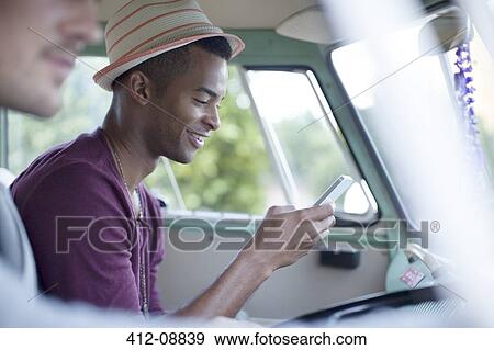 Man using cell phone in camper van View Large Photo Image Stock Photo - Man using cell phone in camper van. Fotosearch