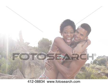 Picture - Portrait of enthusiastic couple hugging. Fotosearch