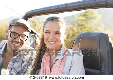Portrait of smiling couple in sport utility vehicle View Large Photo Image Stock Photo - Portrait of smiling couple in sport utility vehicle. Fotosearch