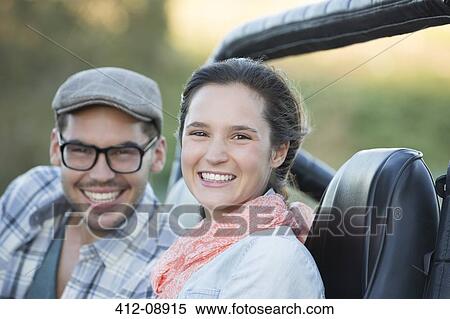 Portrait of smiling couple in sport utility vehicle View Large Photo Image Stock Photography - Portrait of smiling couple in sport utility vehicle. Fotosearch