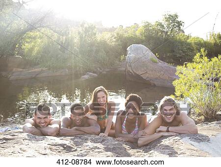 Portrait of smiling friends at riverside View Large Photo Image Picture - Portrait of smiling friends at riverside. Fotosearch