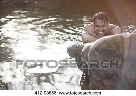 Portrait of smiling man in river View Large Photo Image Stock Photograph - Portrait of smiling man in river. Fotosearch