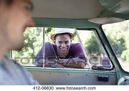 Smiling man leaning on camper van window View Large Photo Image Stock Image - Smiling man leaning on camper van window. Fotosearch