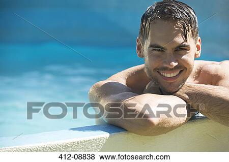 Smiling man relaxing in swimming pool View Large Photo Image Stock Photo - Smiling man relaxing in swimming pool. Fotosearch