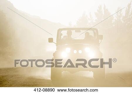 Sport utility vehicle driving on dirt road View Large Photo Image Stock Image - Sport utility vehicle driving on dirt road. Fotosearch