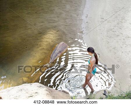 Stock Photo - Woman dipping toe in pool. Fotosearch
