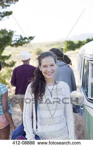 Woman smiling by van on rural road View Large Photo Image Stock Photo - Woman smiling by van on rural road. Fotosearch
