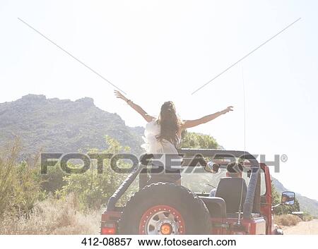 Woman standing in sport utility vehicle View Large Photo Image Stock Photo - Woman standing in sport utility vehicle. Fotosearch