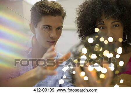 Business people examining ball of string lights View Large Photo Image Stock Photo - Business people examining ball of string lights. Fotosearch