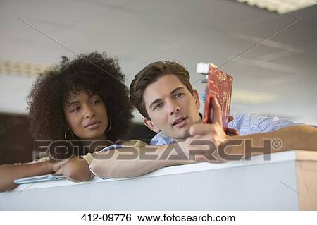 Business people examining circuit board in office View Large Photo Image Stock Photograph - Business people examining circuit board in office. Fotosearch