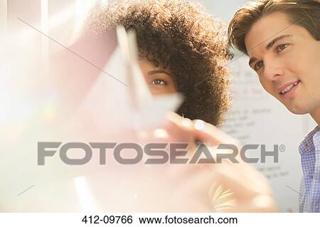 Stock Photograph - Business people looking at model. Fotosearch