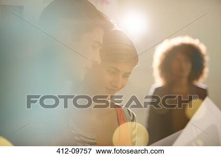 Business people reading paperwork View Large Photo Image Stock Photo - Business people reading paperwork. Fotosearch