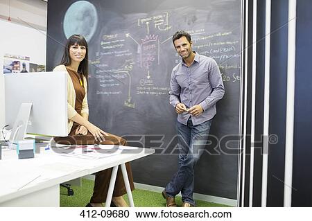 Business people smiling in office View Large Photo Image Stock Image - Business people smiling in office. Fotosearch