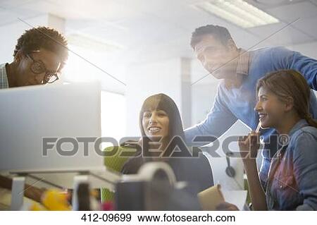 Stock Photo - Business people talking at desk in office. Fotosearch