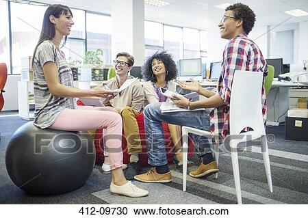 Stock Image - Business people talking in meeting. Fotosearch
