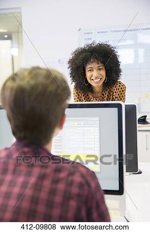 Stock Photo - Business people talking in office. Fotosearch