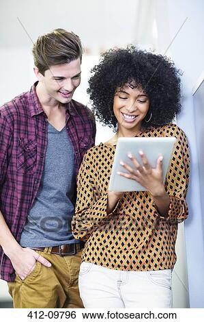 Stock Photograph - Business people using digital tablet in office. Fotosearch