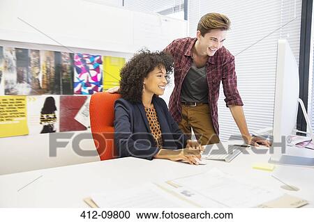 Business people working at computer in office View Large Photo Image Stock Image - Business people working at computer in office. Fotosearch