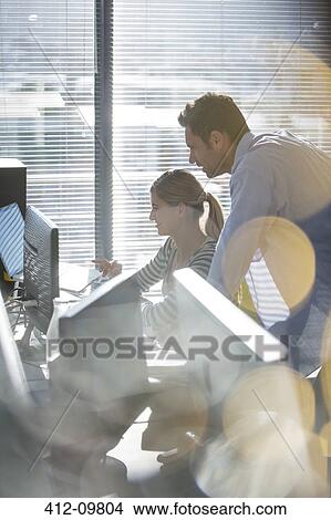 Business people working at computer next to window View Large Photo Image Picture - Business people working at computer next to window. Fotosearch