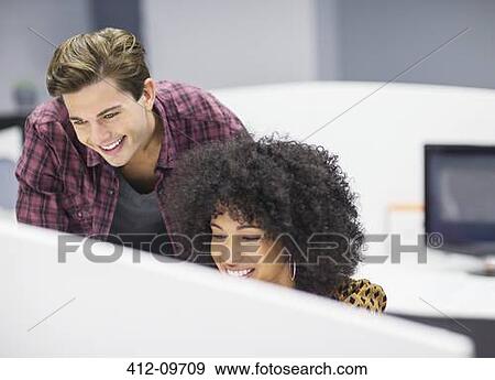 Stock Photo - Business people working in office. Fotosearch