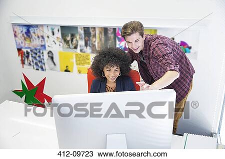 Business people working on computer at desk View Large Photo Image Stock Image - Business people working on computer at desk. Fotosearch