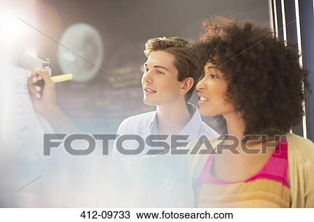 Business people writing on office whiteboard View Large Photo Image Stock Image - Business people writing on office whiteboard. Fotosearch