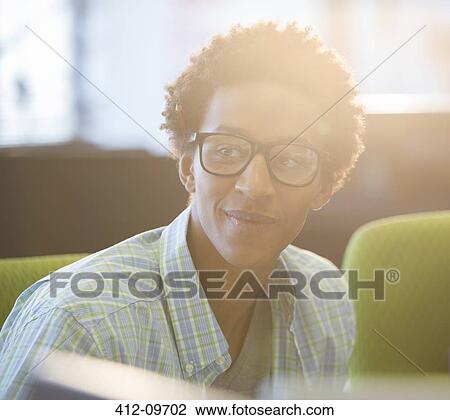 Businessman smiling in office View Large Photo Image Stock Image - Businessman smiling in office. Fotosearch