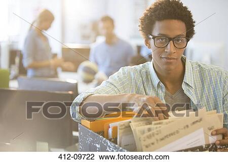 Businessman sorting through files in office View Large Photo Image Stock Image - Businessman sorting through files in office. Fotosearch