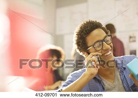Businessman talking on cell phone in office View Large Photo Image Stock Image - Businessman talking on cell phone in office. Fotosearch