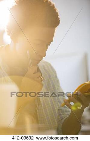 Businessman using cell phone in office View Large Photo Image Stock Image - Businessman using cell phone in office. Fotosearch