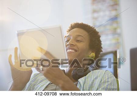 Businessman using digital tablet in office View Large Photo Image Stock Photo - Businessman using digital tablet in office. Fotosearch