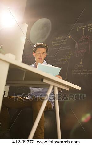 Businessman working at desk in office View Large Photo Image Stock Image - Businessman working at desk in office. Fotosearch