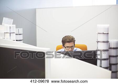 Stock Photo - Businessman working at desk. Fotosearch