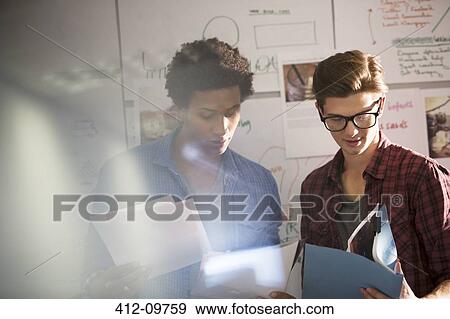 Stock Photo - Businessmen talking in office. Fotosearch