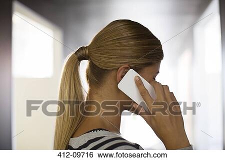 Stock Photograph - Close up of woman talking on cell phone. Fotosearch