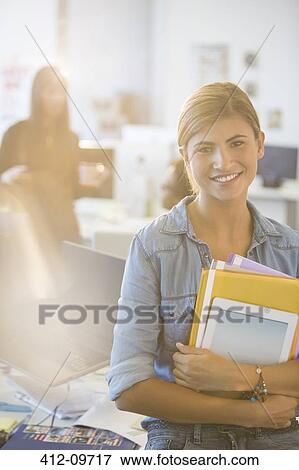 Portrait of businesswoman smiling in office View Large Photo Image Stock Photo - Portrait of businesswoman smiling in office. Fotosearch