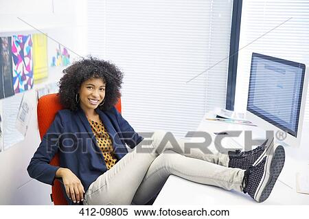 Portrait of businesswoman with feet up on desk View Large Photo Image Stock Photography - Portrait of businesswoman with feet up on desk. Fotosearch