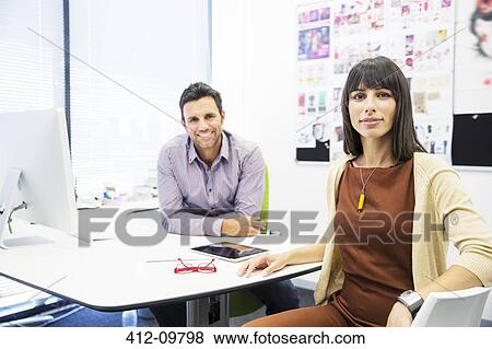 Portrait of smiling business people in office View Large Photo Image Stock Photo - Portrait of smiling business people in office. Fotosearch