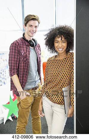 Stock Photograph - Portrait of smiling business people in office. Fotosearch