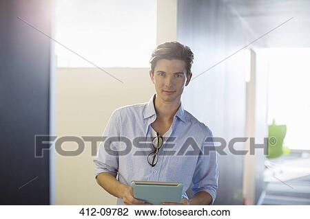 Portrait of smiling businessman in corridor View Large Photo Image Stock Image - Portrait of smiling businessman in corridor. Fotosearch