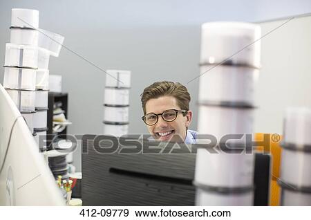 Portrait of smiling businessman surrounded by CD cases View Large Photo Image Stock Photo - Portrait of smiling businessman surrounded by CD cases. Fotosearch