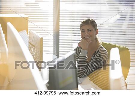 Portrait of smiling businesswoman at desk View Large Photo Image Stock Photography - Portrait of smiling businesswoman at desk. Fotosearch