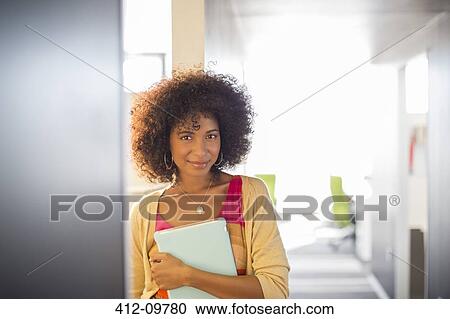 Portrait of smiling businesswoman in corridor View Large Photo Image Stock Image - Portrait of smiling businesswoman in corridor. Fotosearch