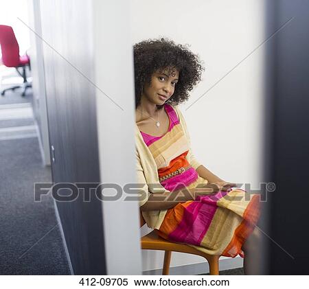 Smiling woman sitting in chair View Large Photo Image Stock Photography - Smiling woman sitting in chair. Fotosearch