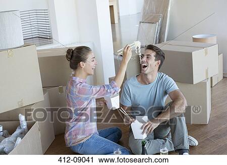 Couple eating Chinese take out food in new house View Large Photo Image Stock Image - Couple eating Chinese take out food in new house. Fotosearch