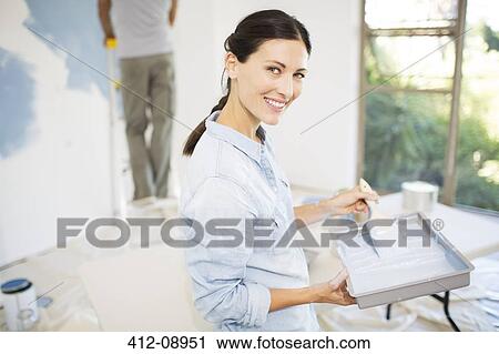 Couple painting wall blue View Large Photo Image Stock Image - Couple painting wall blue. Fotosearch