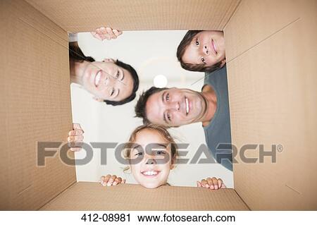 Family looking down at camera through cardboard box View Large Photo Image Stock Image - Family looking down at camera through cardboard box. Fotosearch