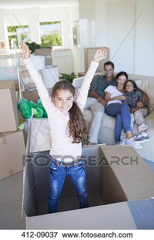 Girl playing inside cardboard box in new house View Large Photo Image Stock Photo - Girl playing inside cardboard box in new house. Fotosearch