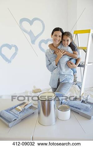 Mother and daughter hugging among paint supplies View Large Photo Image Stock Image - Mother and daughter hugging among paint supplies. Fotosearch