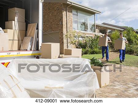 Stock Image - Movers carrying cardboard boxes from house to moving van. Fotosearch